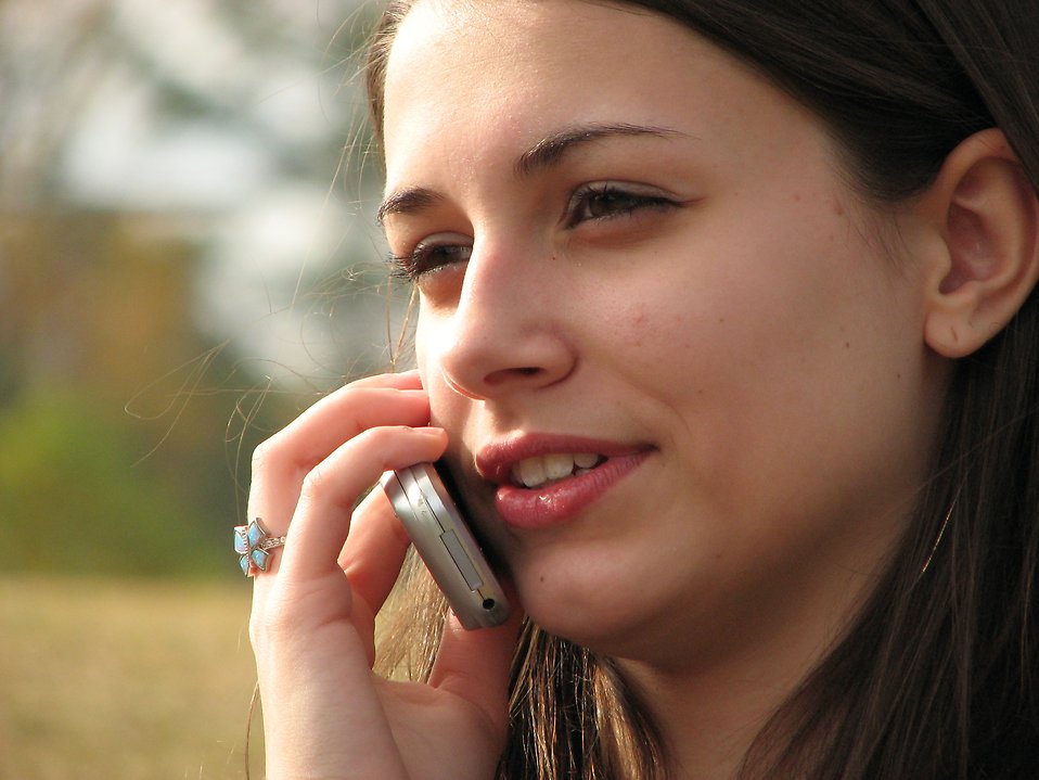 Teenage girl talking on a cell phone : Free Stock Photo