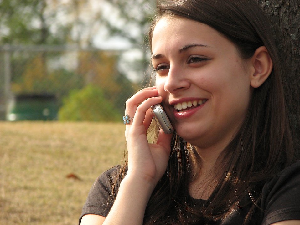 Teenage girl talking on a cell phone : Free Stock Photo