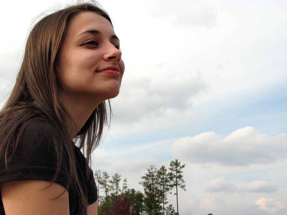 Teenage girl in front of a blue sky : Free Stock Photo