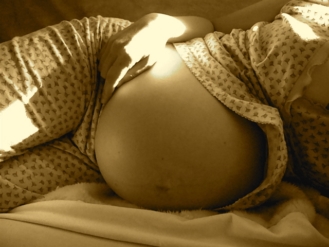 Belly of a pregnant woman in sepia tone : Free Stock Photo