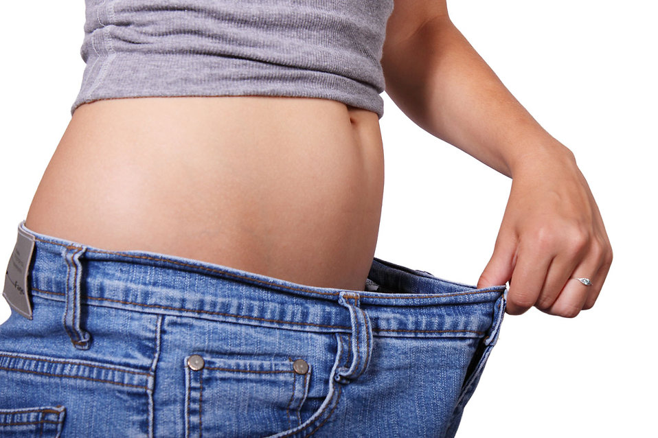 A woman showing off loose jeans : Free Stock Photo