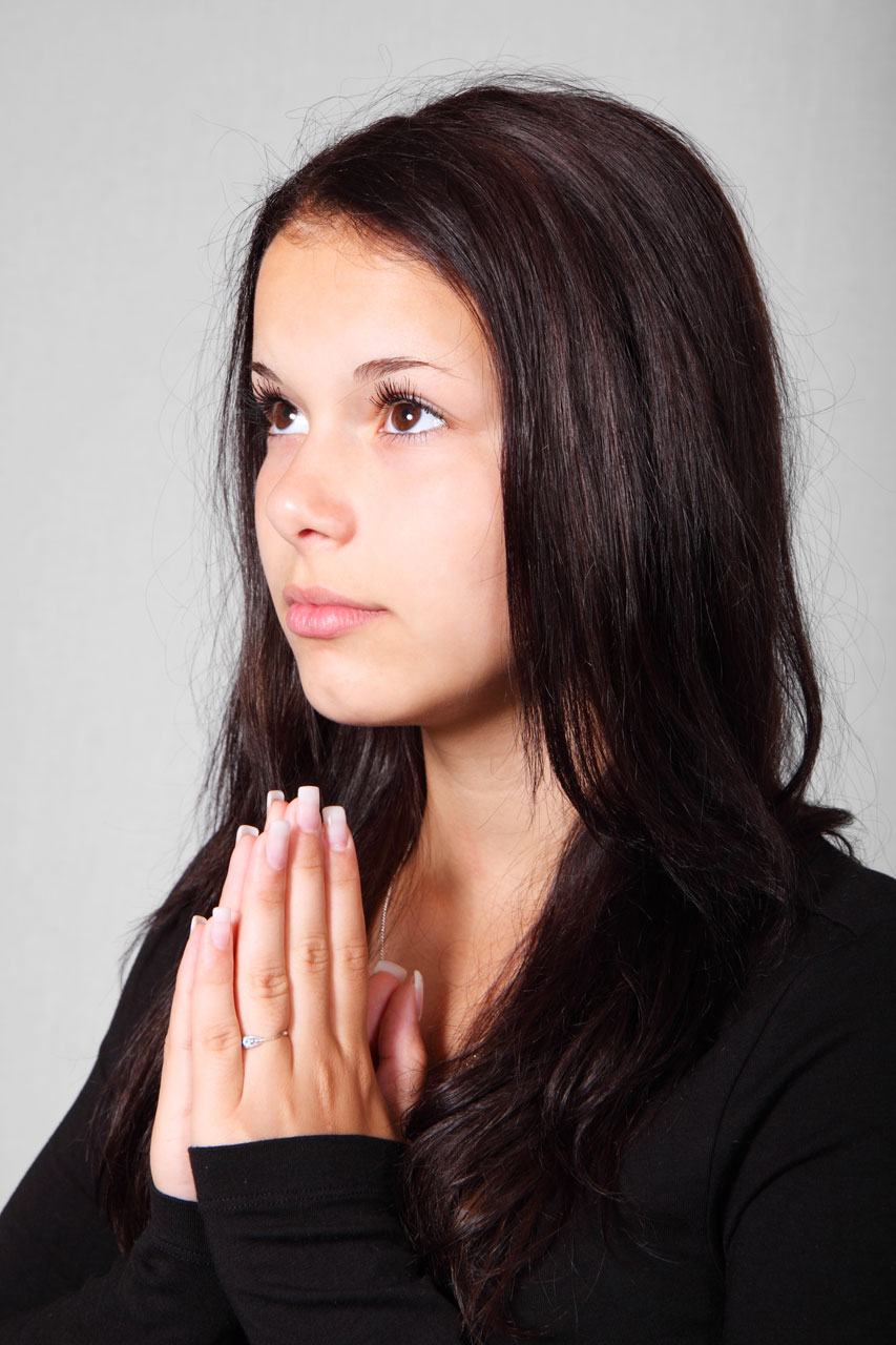 A beautiful young woman praying : Free Stock Photo