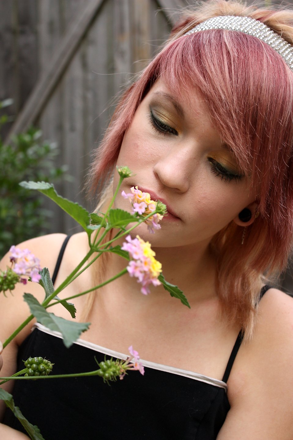 A beautiful young girl smelling flowers : Free Stock Photo