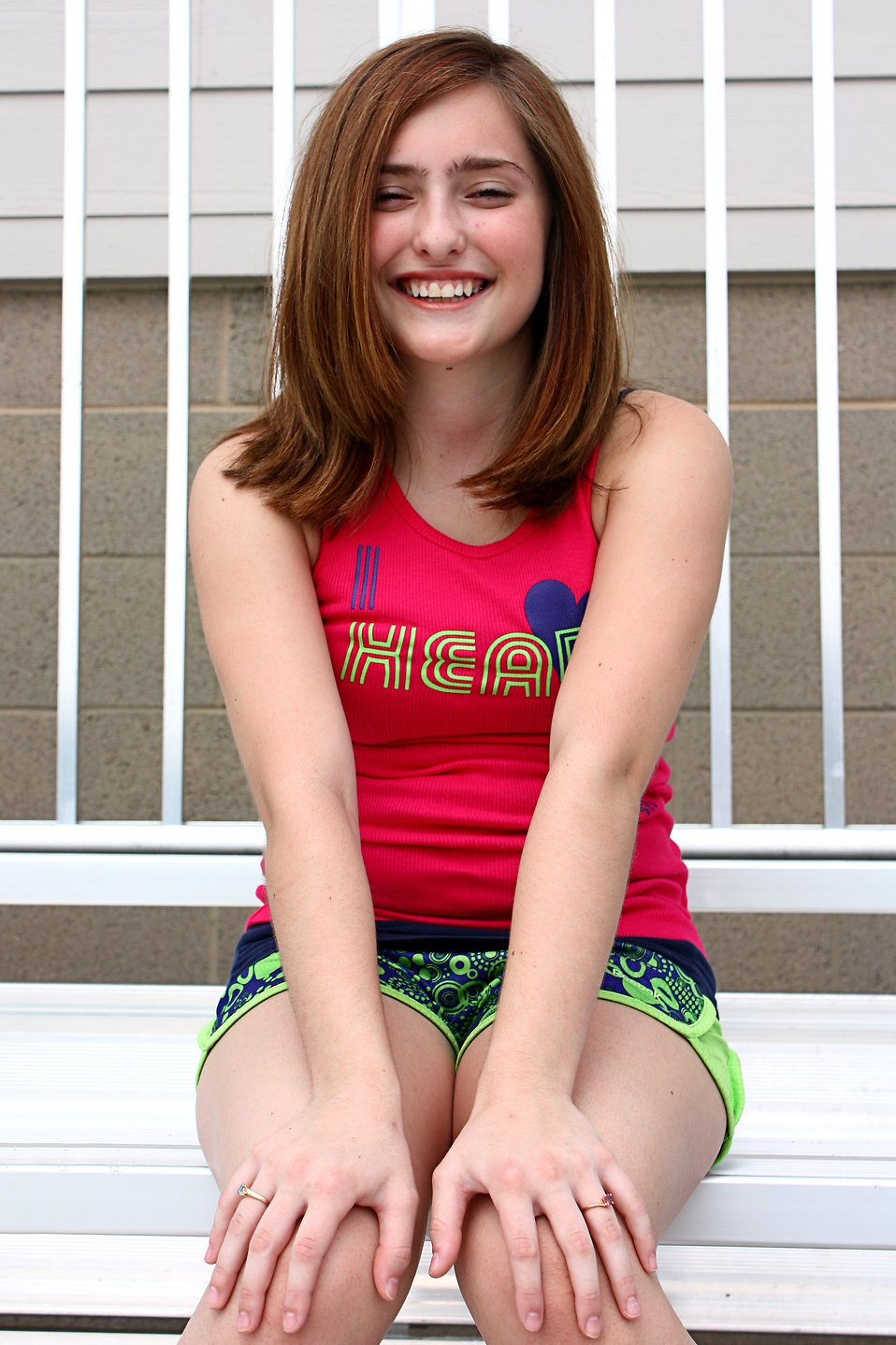 A cute young girl posing outdoors on bleachers : Free Stock Photo