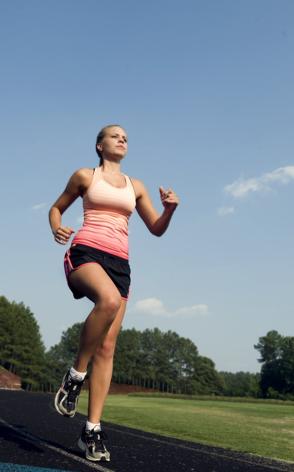 A healthy young woman running outdoors on a track : Free Stock Photo