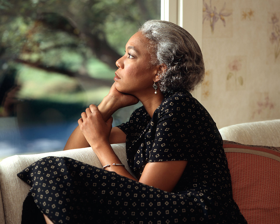 An African-American woman looking out a window : Free Stock Photo