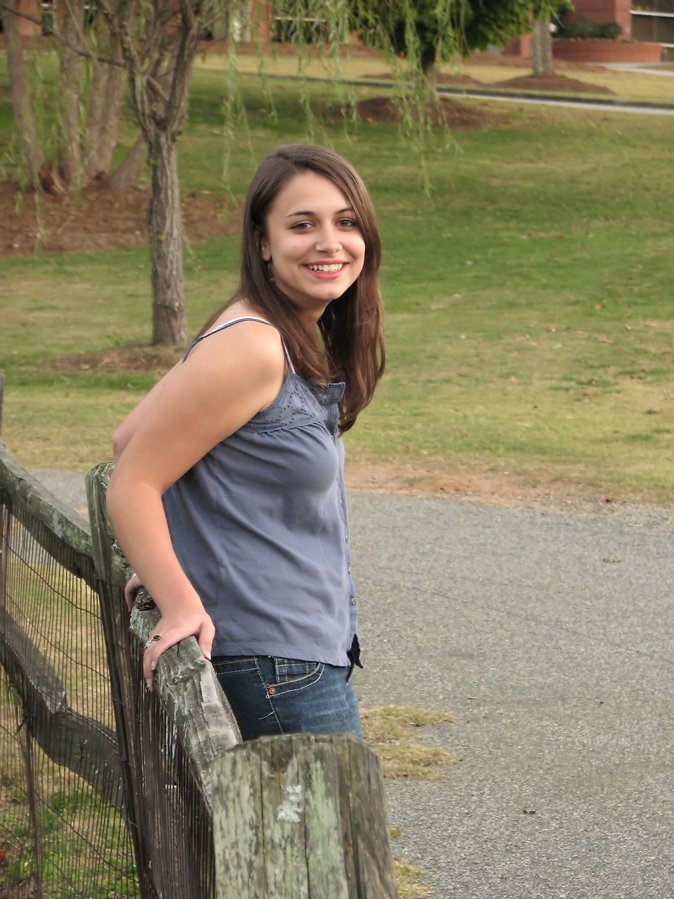 Outdoor portrait of a beautiful teen girl on a wooden fence : Free Stock Photo