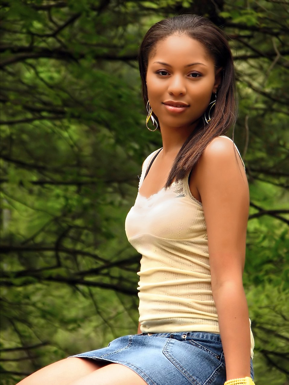 A beautiful African American teen girl posing in the woods : Free Stock Photo