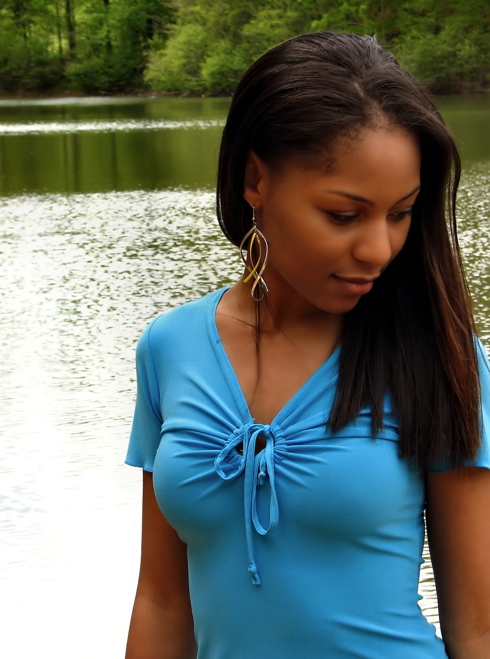 A beautiful African American teen girl posing near a lake : Free Stock Photo