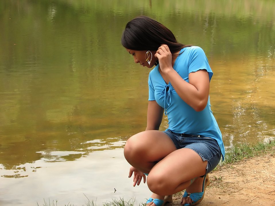 A beautiful African American teen girl posing near a lake : Free Stock Photo