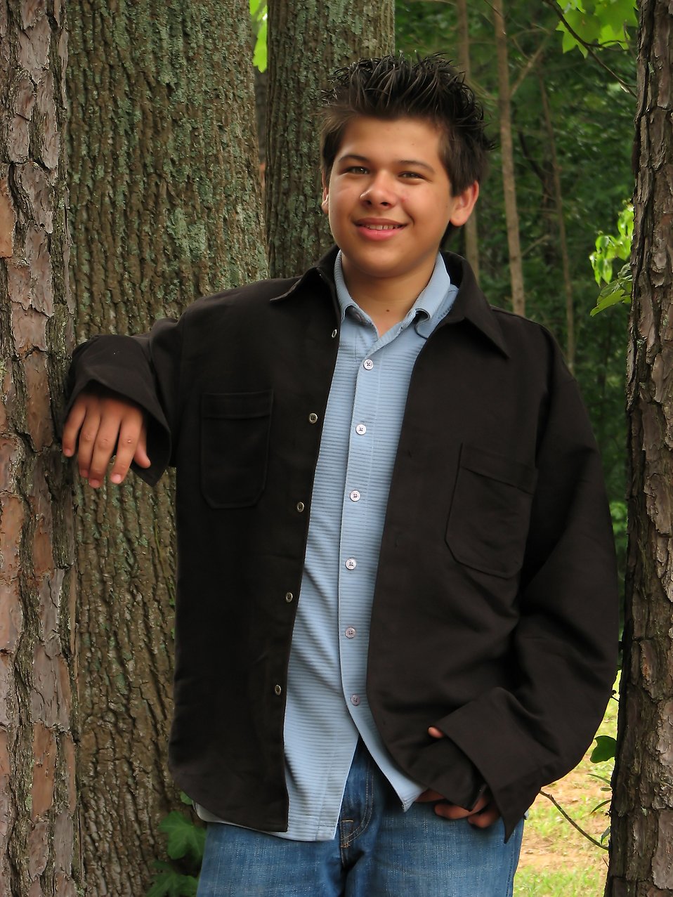 A young latino teen boy posing outdoors by a tree : Free Stock Photo