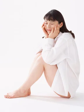 Free Stock Photo: A beautiful woman sitting isolated on a white background