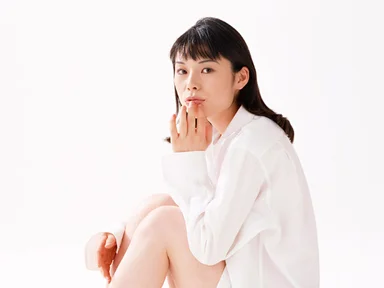 Free Stock Photo: A beautiful woman sitting isolated on a white background