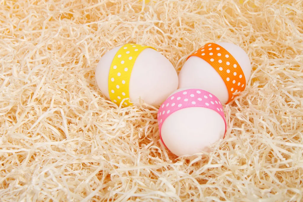 Easter eggs with ribbons on straw : Free Stock Photo