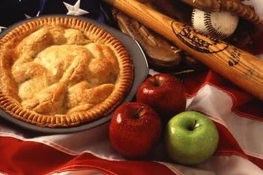 Free Stock Photo: An American pie display with apples, a flag, and baseball equipment