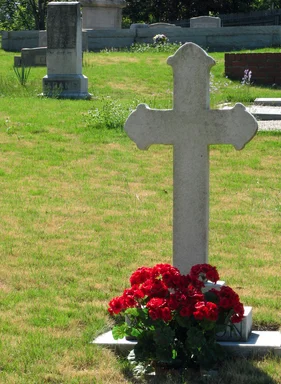 Free Stock Photo: A cross shaped grave stone in a cemetery