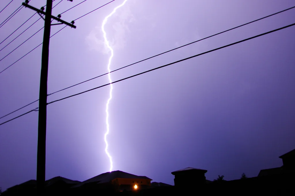 Lightning striking over a house : Free Stock Photo