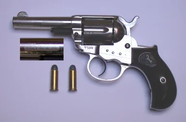 Free Stock Photo: A colt 1877 Lightning pistol with bullets