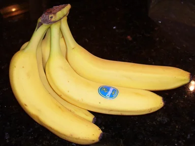 Free Stock Photo: A bunch of yellow bananas on a countertop