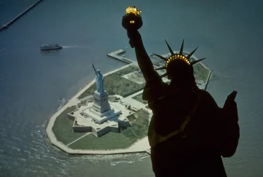 Free Stock Photo: Aerial view of the Statue of Liberty monument on Liberty Island with a superimposed silhouette
