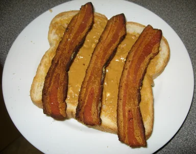 Free Stock Photo: A peanut butter and bacon sandwich on a white plate