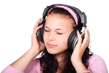 Free Stock Photo: A beautiful girl listening to music with headphones