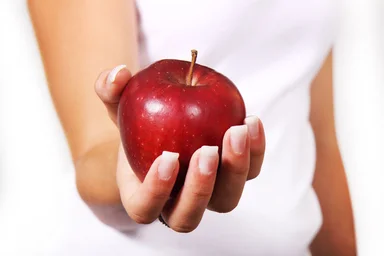 Free Stock Photo: Close-up of a woman holding a red apple in her hand