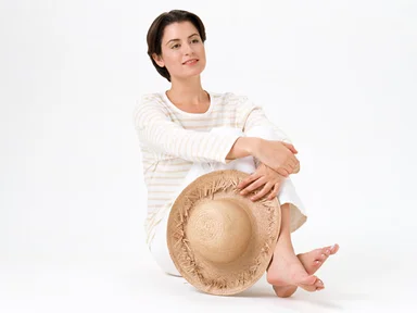Free Stock Photo: A beautiful brunette in casual clothes with a hat isolated on a white background