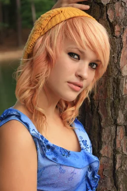 Free Stock Photo: A beautiful young woman posing against a tree by a lake