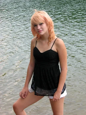 Free Stock Photo: A beautiful young woman posing by a lake