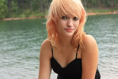Free Stock Photo: Close-up portrait of a beautiful young woman posing by a lake
