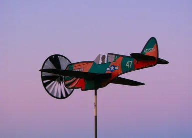 Free Stock Photo: An airplane weather vane with a sunset background