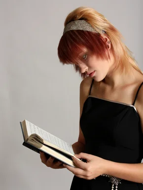 Free Stock Photo: A beautiful young girl reading a book