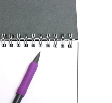 Free Stock Photo: A pad of paper and a pencil isolated on a white background
