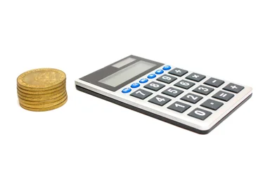 Free Stock Photo: A calculator and a stack of gold coins