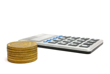 Free Stock Photo: A calculator and a stack of gold coins