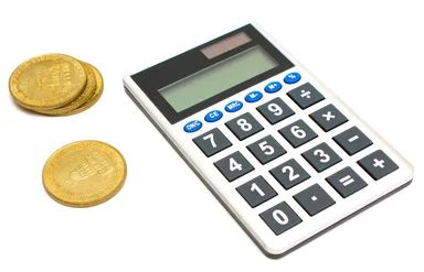 Free Stock Photo: A calculator and a stack of gold coins