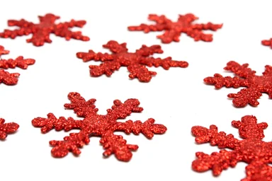 Free Stock Photo: Red snowflake shaped Christmas ornaments isolated on a white background