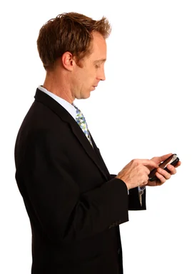 Free Stock Photo: A young businessman using a smart phone