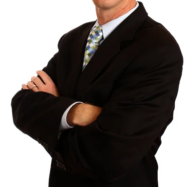 Free Stock Photo: A young businessman in a suit crossing his arms