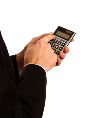 Free Stock Photo: A young businessman in a suit using a calculator