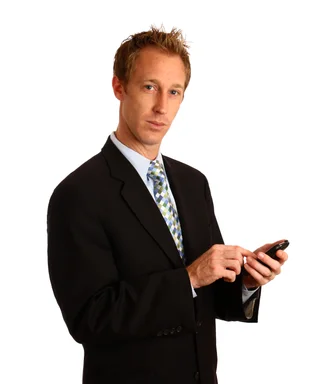 Free Stock Photo: A young businessman using a smart phone