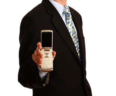 Free Stock Photo: A young businessman holding a cell phone