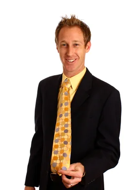 Free Stock Photo: A young businessman in a suit showing off his tie