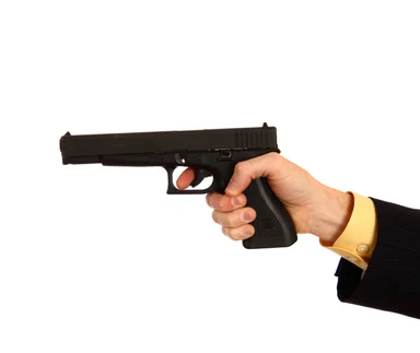 Free Stock Photo: A hand in a business suit holding a pistol
