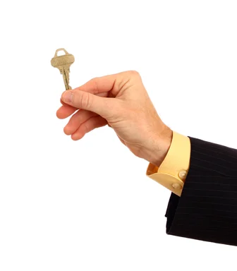 Free Stock Photo: A hand in a business suit holding a key