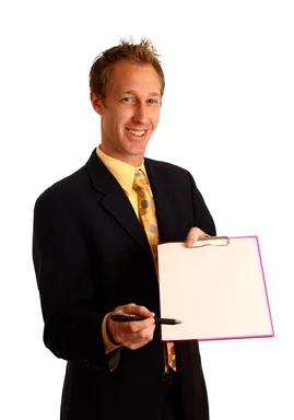 Free Stock Photo: A young businessman in a suit holding a clipboard and pen