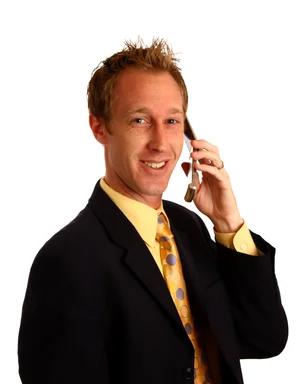 Free Stock Photo: A young businessman in a suit talking on a cell phone
