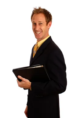 Free Stock Photo: A young businessman in a suit holding a binder