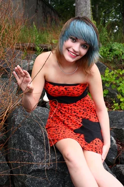 Free Stock Photo: A beautiful young woman posing in a red dress on rocks
